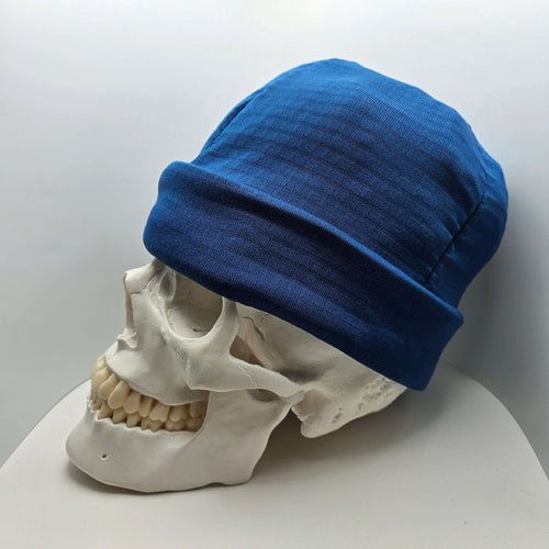 Skully Beanie - All Styles displayed on a skull model, showcasing its comfortable and soft design for outdoor adventures.