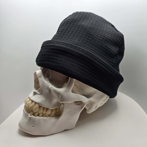 Skully Beanie - All Styles showcased on a skull, highlighting its comfortable, handmade design for outdoor adventures.