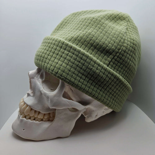 Skully Beanie - All Styles in light green on a skull model, showcasing its comfortable and lightweight design for outdoor activities.