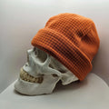 Skully Beanie - All Styles shown on a skull, showcasing its comfortable handmade design for outdoor activities.